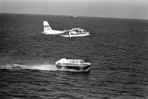 00032 Prints: IslanderO aircraft flies over Cushion Craft Hovercraft, off the Isle of Wight