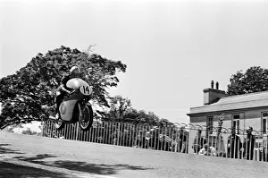 Isle of Man TT Races - Junior International. Mike Hailwood goes over Ballaugh