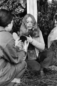 Isle Of Wight Prints: Isle of Wight Festival. A girl combing her hair. Left to right