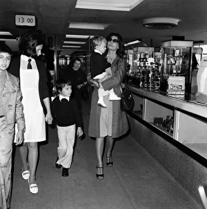 Italian actress Sophia Loren and her two children leaving Heathrow Airport for Rome