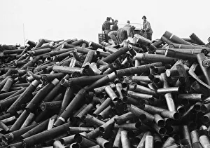Dump Prints: Italian civilians helping Allied soldiers unload empty shell cases at a dump on Anzio