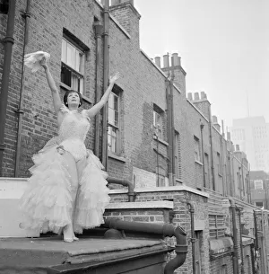 Weird Prints: Italian stage artist Mora Orfei stands on the balcony of her flat cooing to her four