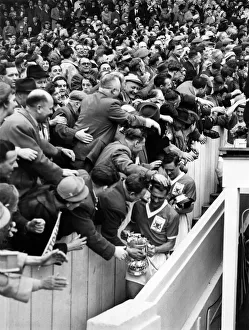 Jack Burkitt, Captain and left-half of Nottingham Forest, carrying cup down gangway