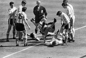 Officials Prints: Jack Charlton (R) on ground about to be kicked by an Argentinian Player