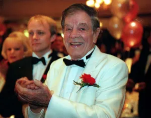 Jack Milroy comedian February 1999 White jacket bow tie red flower clapping hands