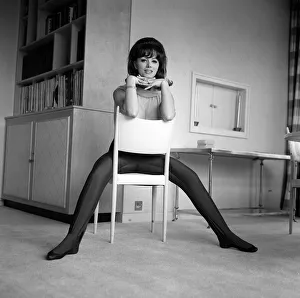 Jackie Collins authoress sitting astride a chair at home Mar 1964
