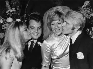 Jackie Irving kisses Tony Hatch while Adam Faith kisses Jackie Trent after the wedding