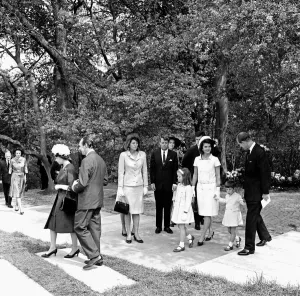 Jackie Kennedy with her children John and Caroline talks with Prince Philip at a memorial