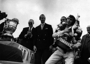 Jackie Stewart after winning British Grand Prix holding trophy