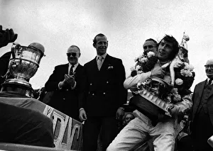 Jackie Stewart after winning British Grand Prix holding trophy July 1969