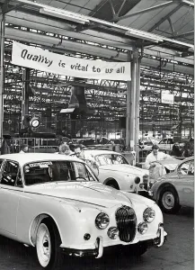 00114 Prints: Jaguar Cars factory, Browns Lane, Coventry. The banner above the track reads