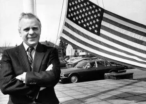 Jaguar Prints: Jaguar Chairman John Egan, hoisted a celebration flag with news that Jaguar has won an