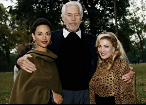 James Coburn American actor stands with his arms around Paula Murad on his left
