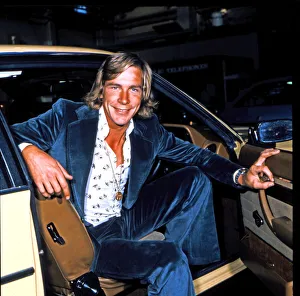 Track Prints: James Hunt, smiles to camera, whilst sitting in the front seat of his car