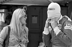 00496 Prints: James Hunt talks to a female friend at a practice day for the British Grand Prix held