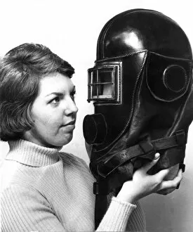 Images Dated 1st April 1975: Jane Ectis looks at a mine rescue helmet on show at a Durham City exhibition in April