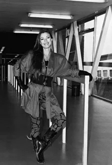 Jane Seymouractress arriving at Heathrow airport leaning on rail