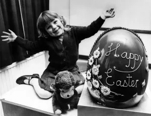 00602 Prints: Janette Lee aged 3, from Wallsend, with giant 25ib 30in high Chocolate Easter Egg donated