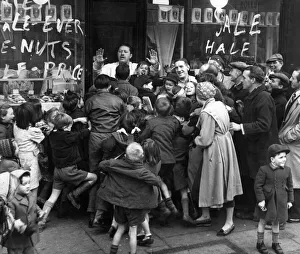 Queue Prints: January Sales. A queue of anxious shoppers try to be first into the shop as the shop