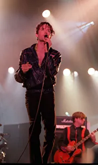 Indie Prints: Jarvis Cocker of pop group Pulp singing into microphone on stage at T in the Park