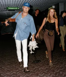Jason Donovan actor and singer with girlfriend Tara Owens as they returned to Britain