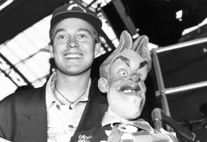 Jason Donovan actor and singer holds Spitting Image Puppet