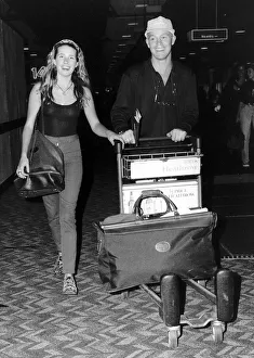 Jason Donovan Actor and Singer leaving Heathrow with gfirlfriend Tara Owen for the far