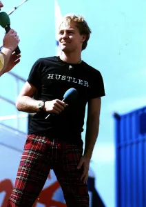 Australian Prints: Jason Donovan at Radio 1 roadshow Irvine beach park black t shirt Hustler tartan trousers