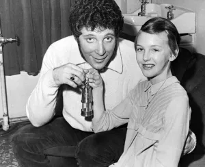 Jayne King, aged 11, presents a miners lamp to Tom jones at the Capitol Theatre, Cardiff