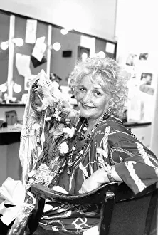 00161 Prints: Jean Boht actress sits in dressing room holding bouquet of flowers May 1989