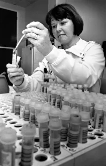 Professionals Prints: Jenny Wright, a medical laboratory scientific officer, preparing a batch of samples