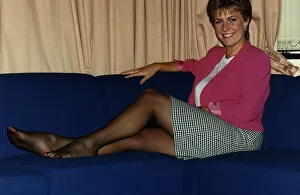 Jill Dando TV Presenter sitting with legs up on sofa on BBC Breakfast time
