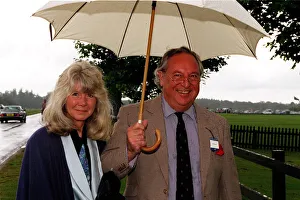 Jilly Cooper writer and husband Leo Cooper arrive in the rain for the Alfred Dunhill