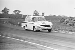 Motor Sports Prints: Jim Clark in the Team Lotus Cortina seen here lifting a wheel through the esses