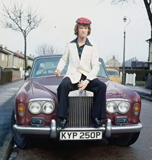 Jim Davidson comedian sitting on the bonnet of an old car KYP 250P A©mirrorpix