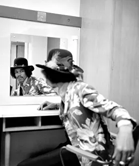 Jimi Hendrix checking his reflection on the date of his new release with Curtis Knight