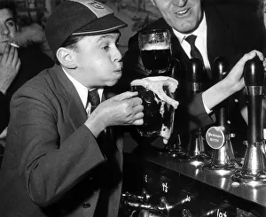 Jimmy Clitheroe watched by Tommy cooper takes time off to one for the road during a break