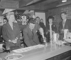 00382 Prints: Jimmy Hill tries his hand at pulling a pint of beer at the official opening of The Rose
