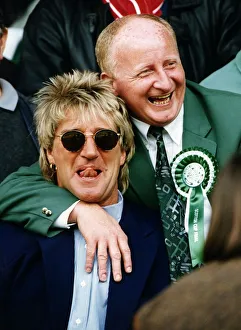 Jimmy Johnstone footballer with arm around singer Rod Stewart smiling tongue