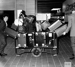 Joan Collins Actress gets porters at Heathrow Airport to move her Luggage