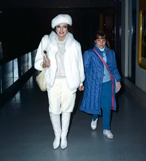 Joan Collins actress leaves Heathrow Airport with daughter Katy, holding hands