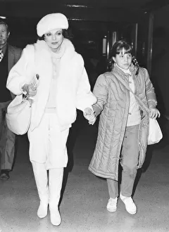 And Child Prints: Joan Collins actress leaves Heathrow Airport with daughter Katy in January 1984