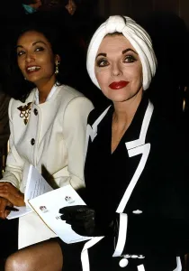 Joan Collins Actress and Shakira Caine sit side by side at a fashion show in London