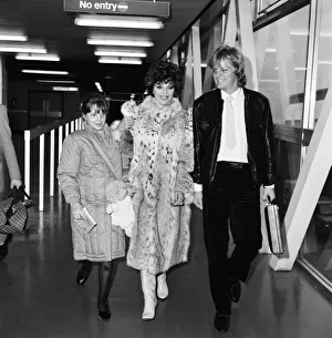 Joan Collins with daughter Katyana Kass and boyfriend Peter Holm at Heathrow after