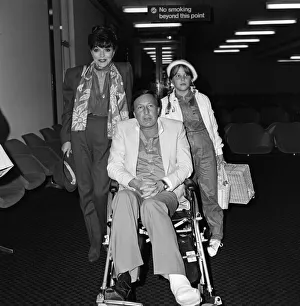 Joan Collins with husband Ron Kass and daughter Katyana arriving at Heathrow from Los