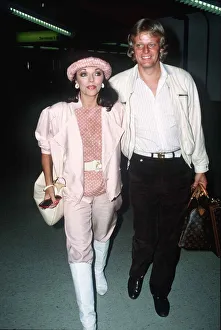 Joan Collins and Peter Holm at London Airport on the way to Nice September