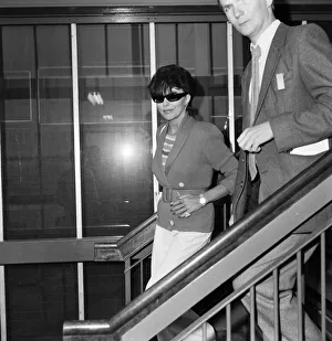 Joan Collins with her son Sacha, 17, arriving at Heathrow from Los Angeles