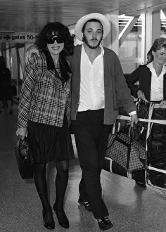 Joan Collins with her son Sacha aged 22 arriving from Los Angeles at Heathrow airport