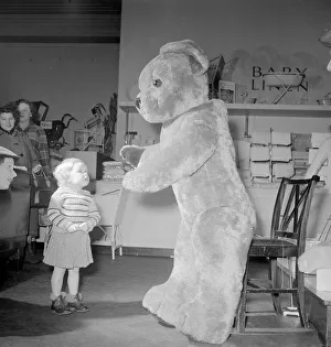 Amazement Prints: Joan Padley seems amazed by the huge teddy bear in the toy department section of Lewis