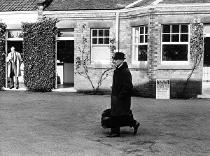00393 Prints: Jockey Arthur Scobie'Breasley, carrying his riding kit into Haydock park